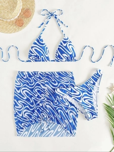 Three-piece bikini set with blue swirl pattern including halter top, bottom and beach skirt