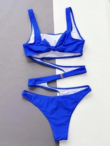 Detail of royal blue monokini featuring an S-shaped cutout and back bow tie design