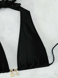 Detail of ribbed black halter bikini top with golden seashell and starfish charms