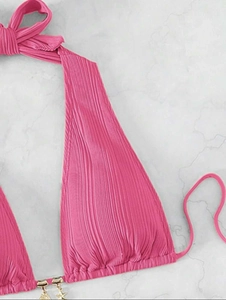 Detail of pink halter bikini top featuring vertical pleats and golden starfish charms