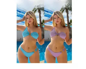Detail of ribbed bikini set with one-shoulder cut and gold metal buckle accents