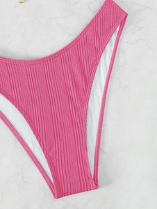 Detailed view of pink high-waisted bikini bottoms featuring vertical ribbed texture fabric