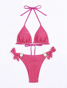 Detail view of fuchsia bikini top with ruched texture and elegant halter string ties