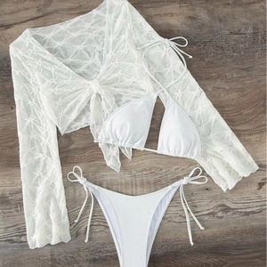 Three-piece white bikini set with halter top, tie-side bottom and mesh cover-up