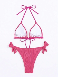 Detail of rose red ribbed bikini set featuring vertical ruching texture and side ties