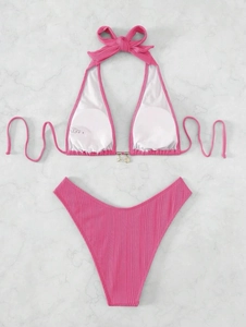 Detailed flat lay of rose pink ribbed bikini with halter top and high-cut V-waist bottoms