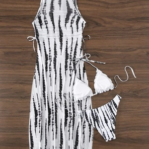 Three-piece bikini set with tie-dye print mesh cover-up long skirt on wooden background