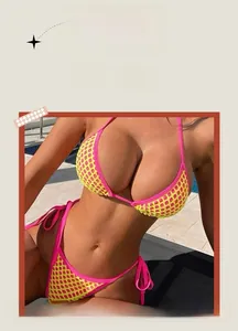 Detail of neon yellow mesh bikini with pink trim and adjustable side tie strings