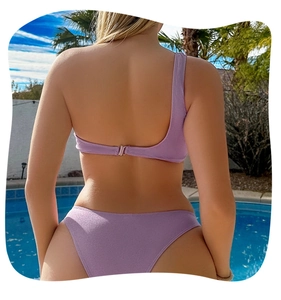 Back view of a light purple one-shoulder bikini featuring a secure metal clasp closure