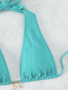 Detail of ribbed turquoise bikini top with gold seashell and starfish charm pendants
