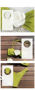 Detail of green bikini set with 3D white floral applique and halter neck tie design
