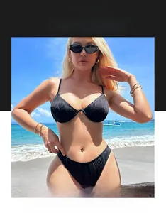 Detail of black ribbed bikini set with underwire top and high cut bottoms on the beach