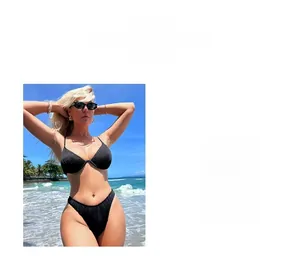 Detail view of black ribbed bikini showing textured fabric and high cut triangle bottom
