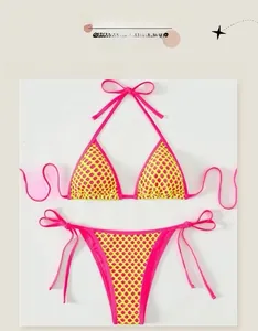 Flat lay of pink and neon green honeycomb mesh bikini set with side-tie strings