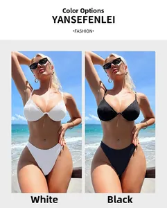 Detail showing the vertical ribbed texture of a white and black bikini set on beach
