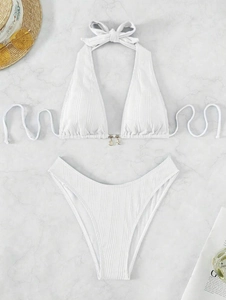 Detail of white ribbed bikini with halter tie and golden seashell and starfish charms