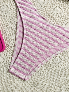 Detailed view of pink striped seersucker bikini bottoms with textured fabric finish