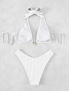 Detail of white ribbed bikini top featuring gold shell and starfish metallic charms