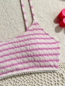 Close-up of pink and white striped smocked bikini top with delicate pom-pom lace trim