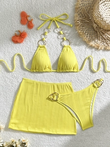 Three-piece yellow ribbed bikini set with metal ring details and matching mini skirt