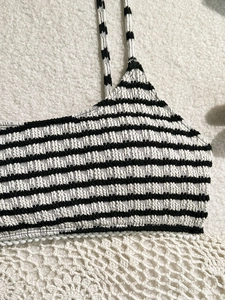 Chic black and white striped bikini top in textured seersucker fabric for beach vacations