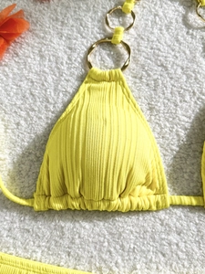 Three-piece vibrant yellow ribbed bikini set with decorative gold ring and neck strap