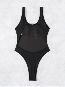 Sexy backless one-piece swimsuit in black with high-cut design on marble background
