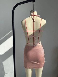 Vista dettagliata del bikini rosa con paillettes e gonna a portafoglio su manichino dal retro