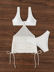Close-up of white knit bikini set with metal ring detail and crochet mesh texture