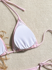 Detail view of pink bikini top with ribbed texture fabric and white removable chest pads
