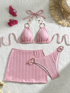 Detailed view of pink 3-piece bikini with ribbed texture and gold metal ring accents