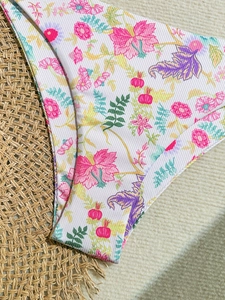 Detailed macro view of tropical floral print on white ribbed bikini fabric texture