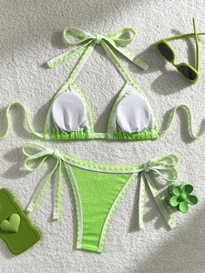 Detail of green and white bikini set with textured fabric and triangular wavy trim