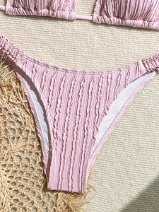 Pink bikini set with ruffled texture and ribbed fabric for a stylish summer beach look