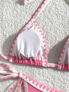 Detail of pink scalloped edge bikini with textured seersucker fabric and halter straps