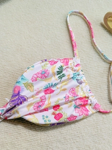 Close-up of floral bikini top showing pink flower pattern and ribbed fabric texture