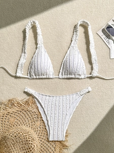 Detailed view of white ribbed bikini with halter top and textured vertical fabric