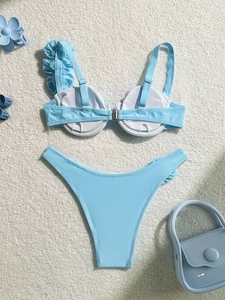 Detail view of light blue bikini top with underwire cups and elegant ruffled shoulder straps