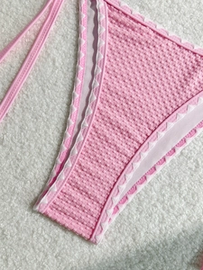 Pink seersucker bikini with white scalloped trim and textured bubble fabric detail