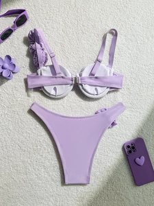 Flat lay of light purple bikini with floral shoulder detail and underwired cups