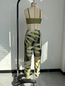 Detail of sexy olive green mesh beach trousers with tropical leaf print and crop top set