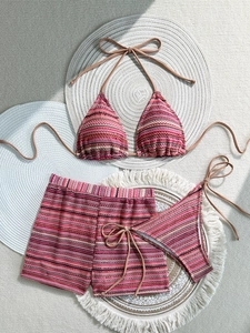 Detailed view of women's three-piece bikini set with striped knit texture and beach shorts
