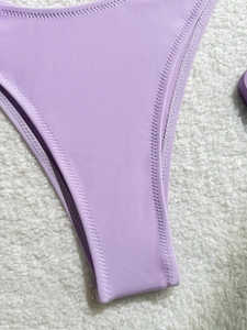 Close-up of lavender bikini bottom featuring high-cut design and zigzag stitch detail
