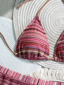Detail of colorful striped crochet bikini featuring intricate handmade knit texture