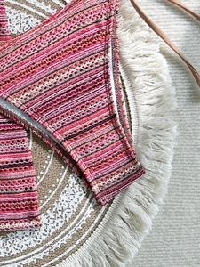 Detail of multi-color crochet stitching and bohemian striped texture on bikini swimsuit