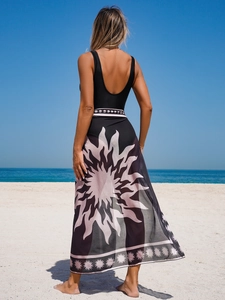 Two-piece beach set featuring a black bikini top and a sun-print mesh wrap long skirt