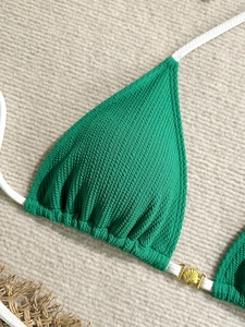 Green textured bikini top with white halter straps and golden shell charm detail