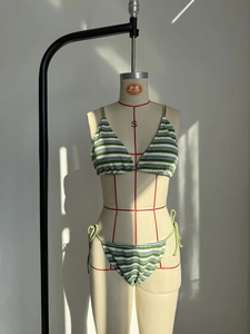 Detail of striped terry cloth bikini fabric showing green and blue textured pattern