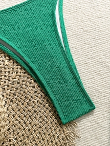 Solid green ribbed halter bikini set for women featuring vibrant textured fabric