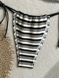 Textured black and white striped bikini bottom with side ties and high-cut leg opening